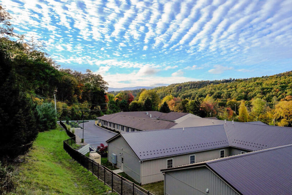 Aerial drone view of STR Behavioral Health Silver Pines facility surrounded by trees at detox and residential treatment center for addiction and mental health disorders.