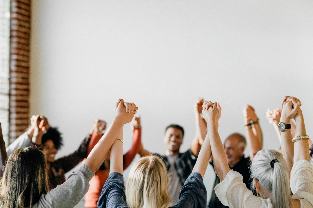 Friends celebrating in group therapy session